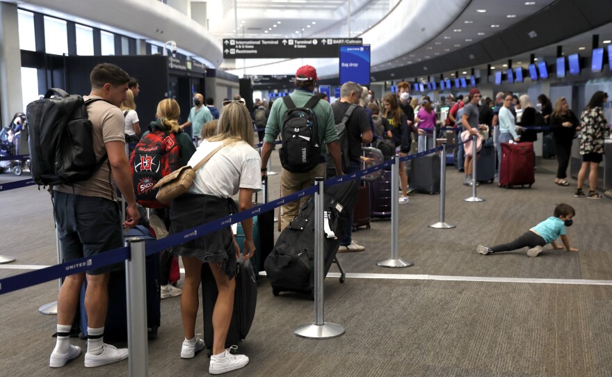 Travelers line up to check in for United Airlines flights at San Francisco International Airport on July 1, 2022 in San Francisco, Calif. This summer is expected to be a record for air travel.