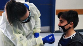 A student getting a nasal swap for the coronavirus test in this undated photo released by the San Diego Unified School District.