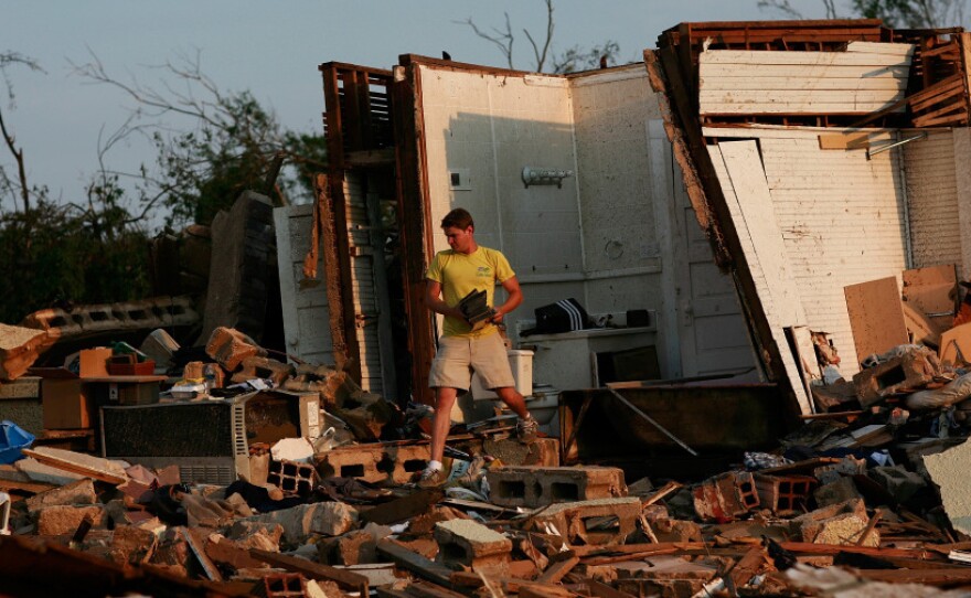 University of Alabama student Clayton Farr gathers his belongings from his destroyed home in Tuscaloosa, Ala. The twisters mostly avoided the main campus, but many students and staff living off campus are dealing with devastation.