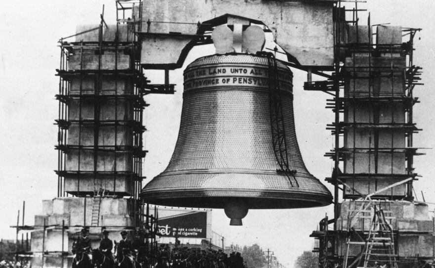 A cavalry regiment leads the inaugural parade beneath a huge reproduction of the Liberty Bell at the 1926 world's fair in Philadelphia.