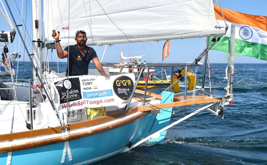 India's Abhilash Tomy gestures on his boat Thuriya as he sets off from Les Sables d'Olonne Harbour on July 1 at the start of the solo around-the-world "Golden Globe Race" ocean race in which sailors compete without high technology aides such as GPS or computers.