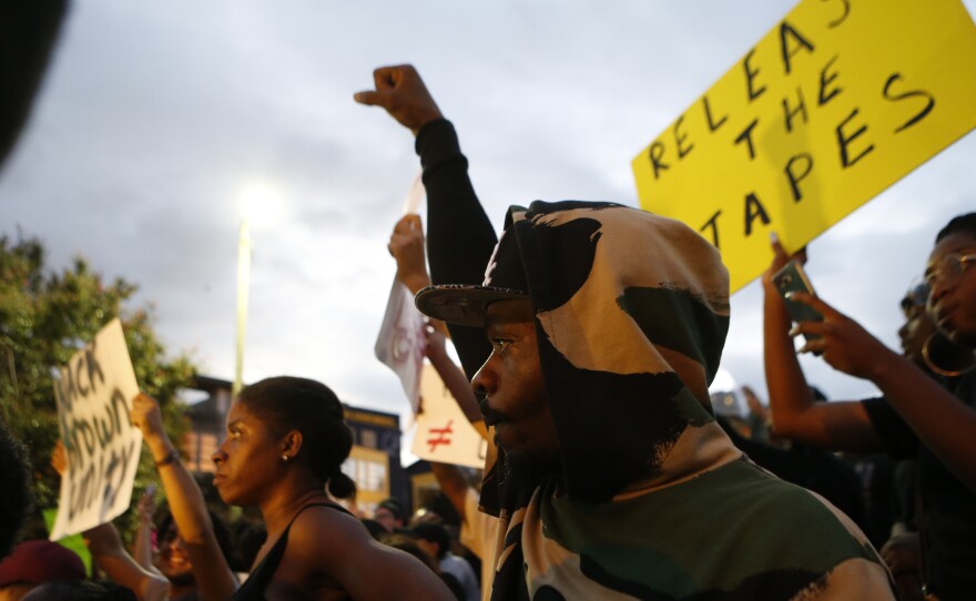 Residents gather Wednesday for a vigil and march to protest the death of Keith Scott in Charlotte, N.C. Scott, who was black, was shot and killed by police. The circumstances of his death are disputed, and residents, the NAACP and the ACLU are calling for the release of police video footage of the shooting.