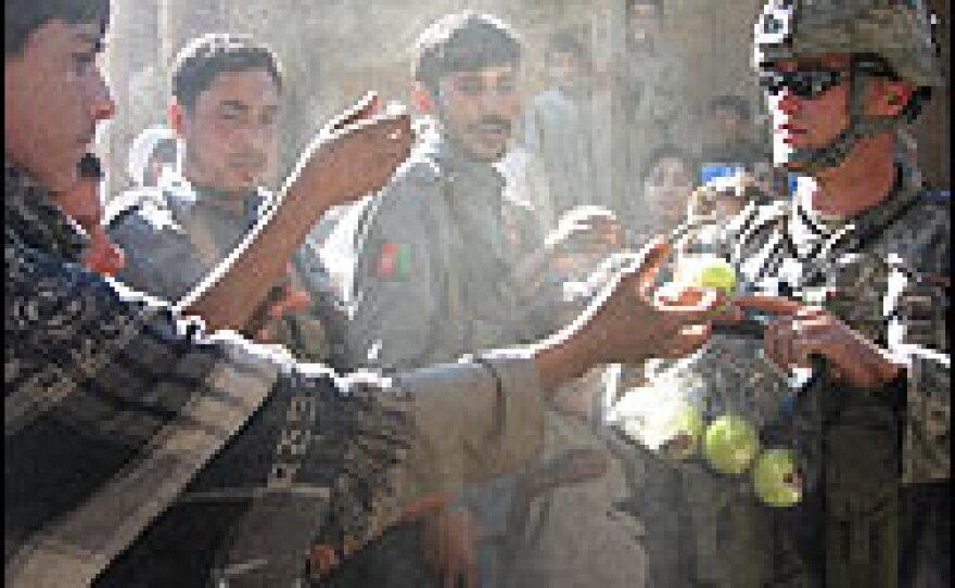 Staff Sgt. Dawayne Krepel prepares to hand out cricket balls to eager Kandagal youngsters.
