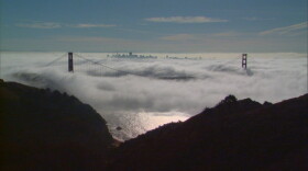 The Golden Gate Bridge and San Francisco skyline through the fog.
