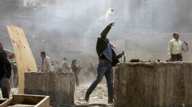An Egyptian anti-government demonstrator battles pro-government opponents in Cairo's Tahrir Square on Thursday.

