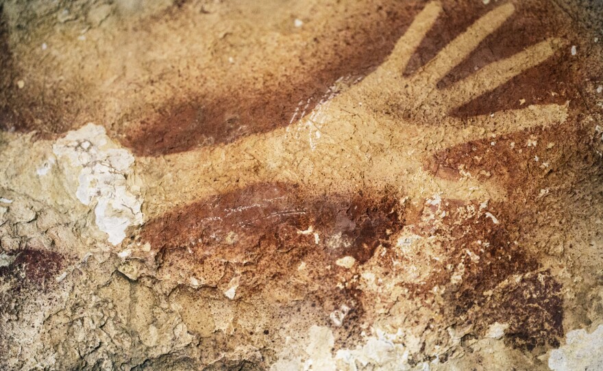 A stencil of an early human's hand in an Indonesian cave is estimated to be about 39,000 years old.