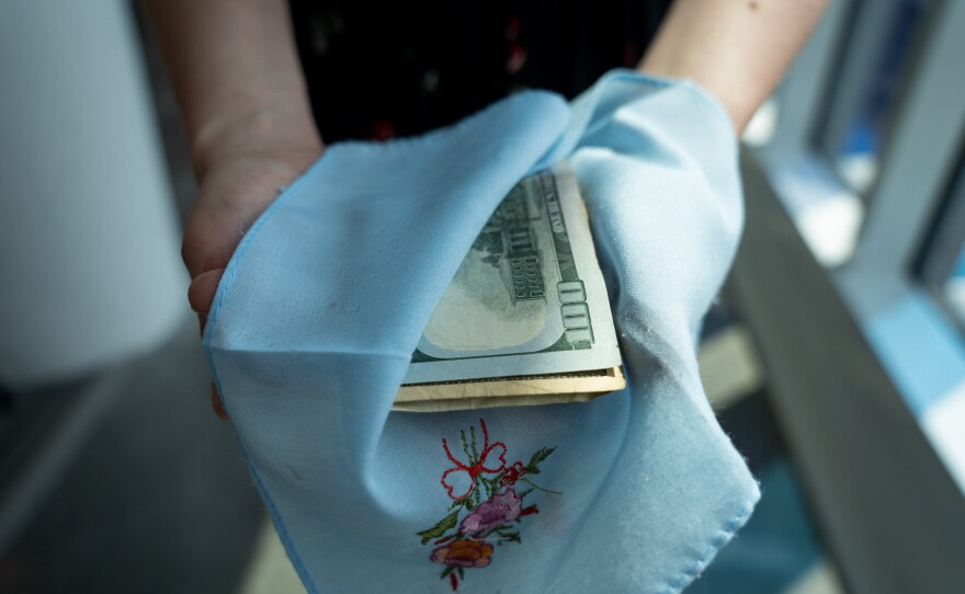 NPR's Alina Selyukh shows how she wrapped tuition money in this handkerchief before safety-pinning it inside her pocket when she traveled to the U.S. for college in the late 2000s.