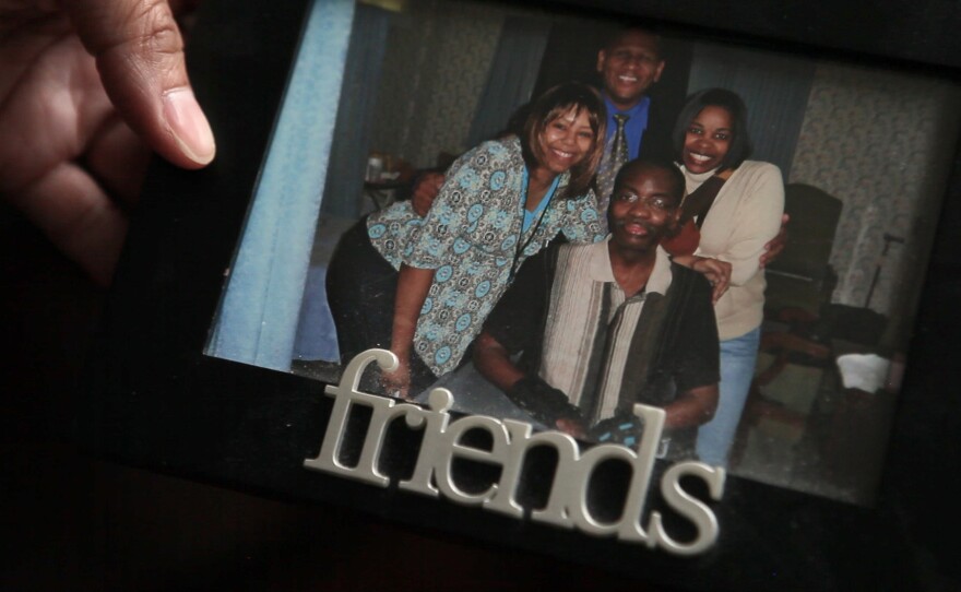 Kelli Glenn holds a photo of her father while he was in the hospital.
