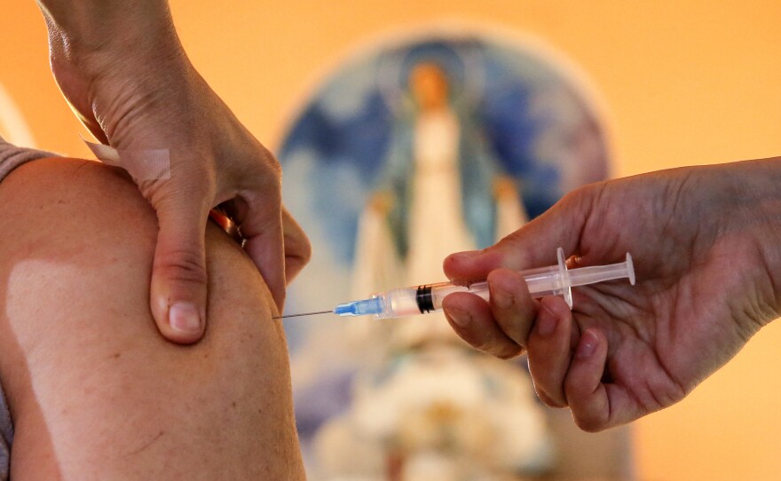 A health worker administers a dose of the Pfizer BioNTech vaccine against COVID-19, at the Medalla Milagrosa Church in Valparaiso, Chile, on April 6.