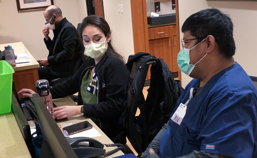 Mary Venus, a nurse from the Philippines, and Pae Junthanam, a nurse from Thailand, talk during their shift at Billings Clinic in Billings, Mont.