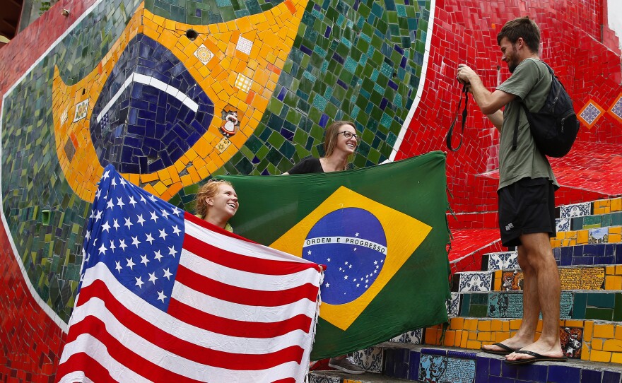 Tourists pose with a U.S. and Brazilian flag ahead of the 2014 World Cup in Rio de Janeiro.