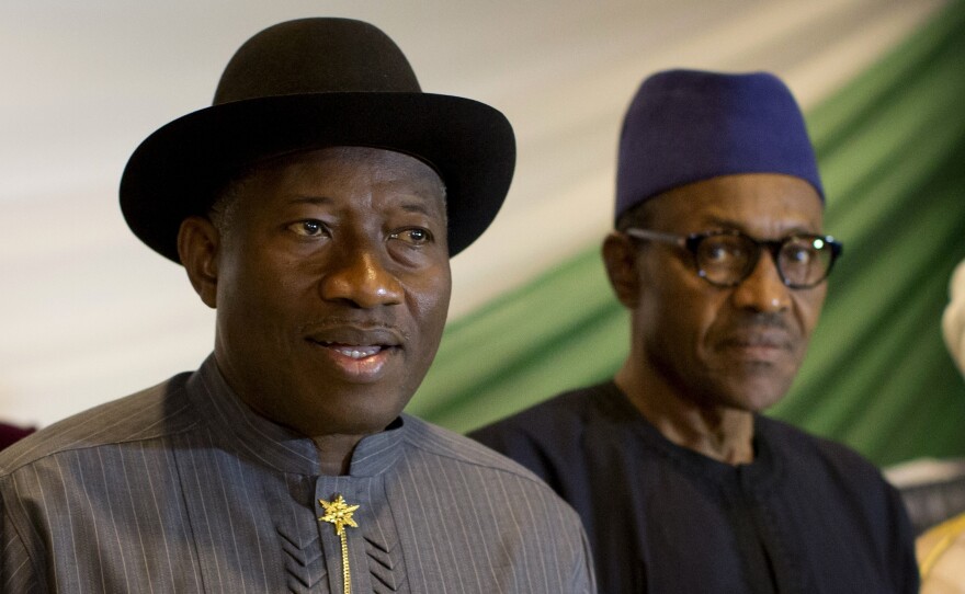 Nigeria's President Goodluck Jonathan, left, and opposition candidate Gen. Muhammadu Buhari, right, prepare to sign a renewal of their pledge to hold peaceful "free, fair, and credible" elections, at a hotel in the capital Abuja, Nigeria, on Thursday.