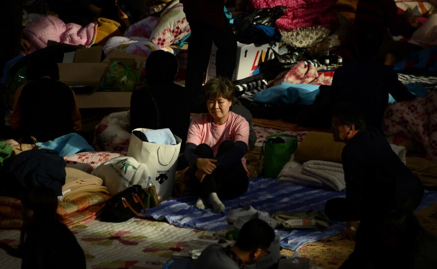 A relative sits in a gymnasium in Jindo, South Korea, where the families of people who are aboard the sunken South Korean ferry Sewol have gathered to await news from the recovery effort.