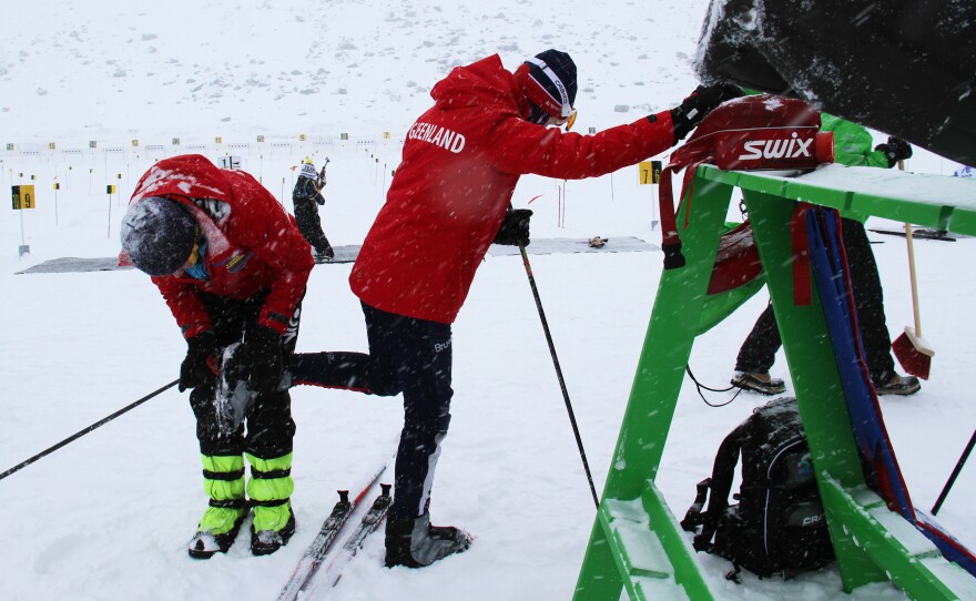 Greenlandic biathlon competitor Ukaleq Slettemark, 14, gets help cleaning her ski bindings from Uiloq Slettemark, her mother and coach,pre-race at the Arctic Winter Games. Ukaleq won in her age group.