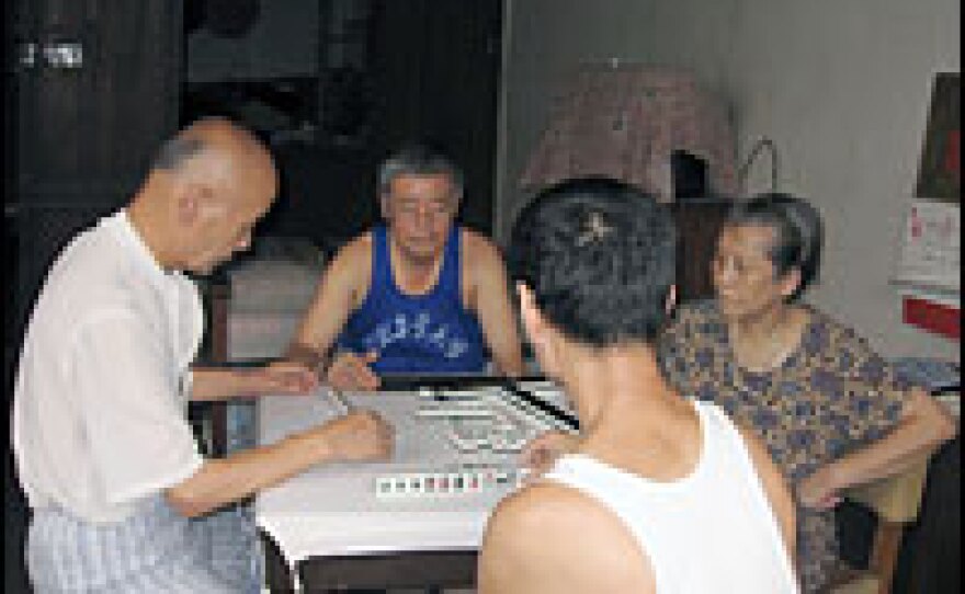 Neighbors play mahjong in Shu's grandmother's room. Shu no longer lives in Dazhongli.