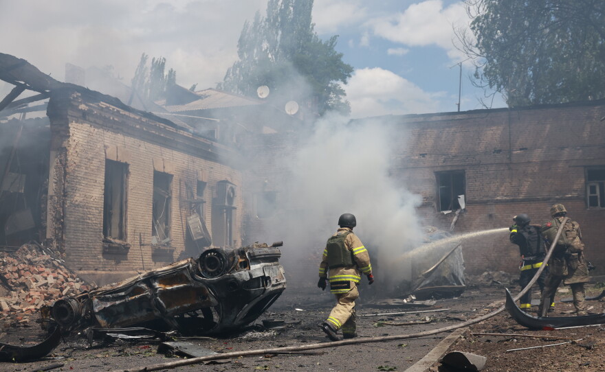 Rescue workers put out a fire at a building destroyed after a Russian strike on Zaporizhzhia, Ukraine, on Friday.