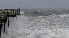 An onlooker checks out the heavy surf at the Avalon Fishing Pier in Kill Devil Hills, N.C., Thursday, Sept. 13, 2018 as Hurricane Florence approaches the East Coast.