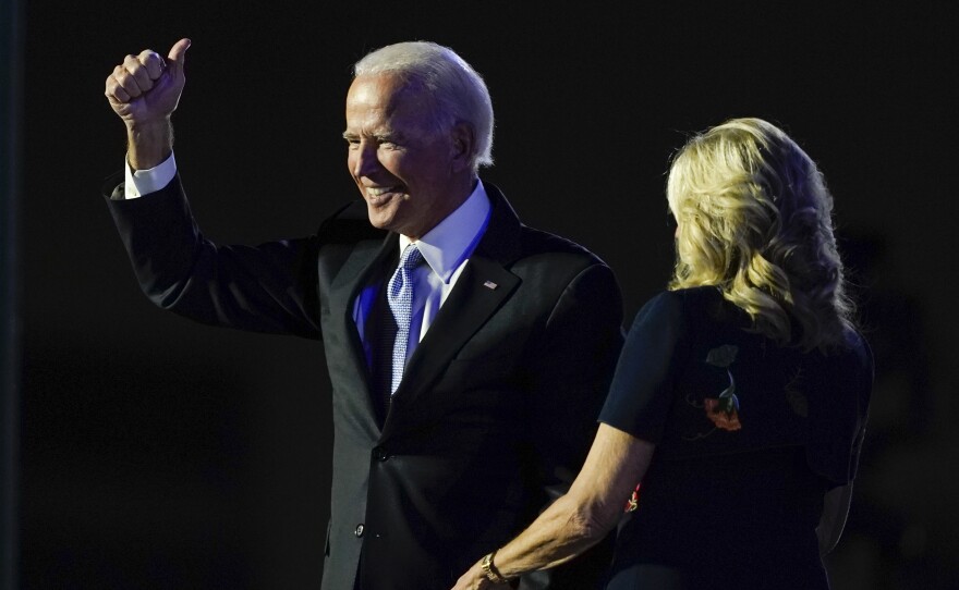 President-elect Joe Biden stands on stage with his wife Jill Biden Saturday, Nov. 7, 2020, in Wilmington, Del.