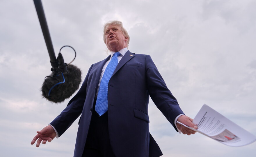 President Donald Trump speaks with reporters before boarding Air Force One, Friday, Aug. 14, 2026, at Joint Base Andrews, Md.
