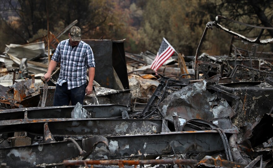 Noah Fisher looks over his home that was destroyed by the Camp Fire in November 2018 in Paradise, California. Investigators are examining whether PG&E power lines helped ignite the fire.