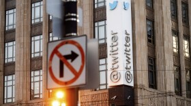 A sign hangs at Twitter headquarters in San Francisco, Jan. 11, 2021.