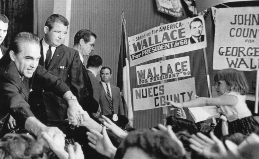 Presidential candidate George Wallace reaches out for the hands of his supporters at the Texas State Convention of his American Independent Party, Dallas, Sept. 17, 1968.
