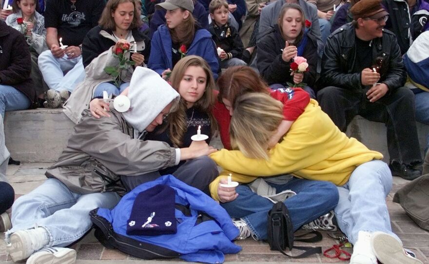 Denver area residents gather the day after the April 20, 1999 shooting at Columbine High School.