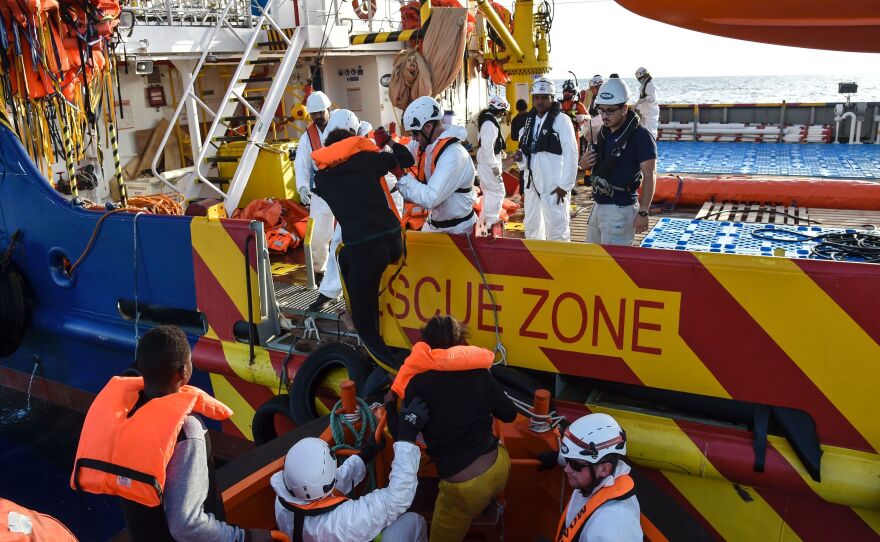 People board a rescue ship off the Libyan coast in the Mediterranean Sea on Thursday.