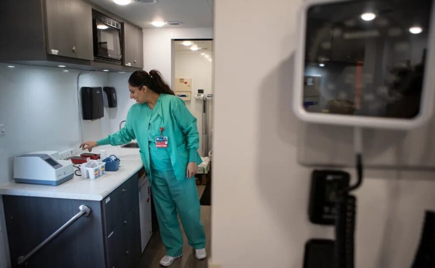 Dr. Navdeep Lehga sets up equipment in the exam room of the Saint Agnes Mobile Health Unit mobile clinic parked in the parking lot of Rojas Pierce Park in Mendota on Aug. 28, 2025.