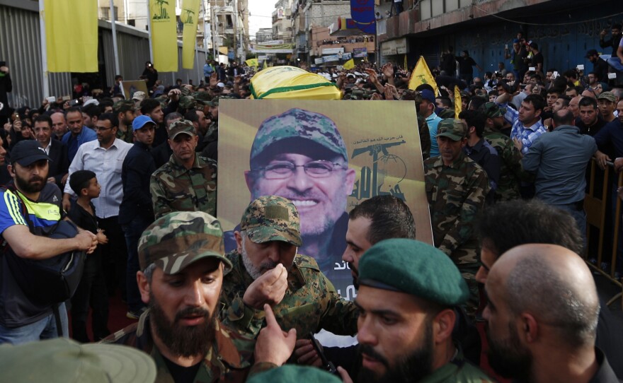 Hezbollah supporters carry the coffin of their slain top commander Mustafa Badreddine during his funeral procession in a southern suburb of Beirut, Lebanon, on Friday.