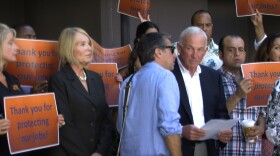 Jason Roe, a spokesman for the San Diego Small Business Coalition, talks to San Diego Regional Chamber of Commerce CEO Jerry Sanders at a news conference announcing the group has enough signatures to force a vote on the minimum wage increase, Sept. 16, 2014.