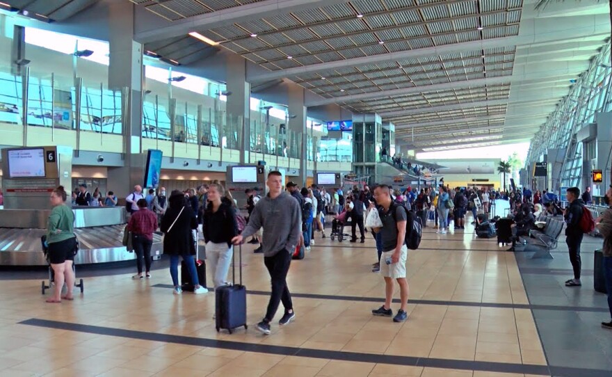 Travelers waiting to claim their baggage inside Terminal 2 of the San Diego International Airport on May 30, 2022.