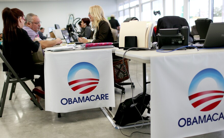 (Left to right) Aymara Marchante and Wiktor Garcia talked with Maria Elena Santa Coloma, an insurance advisor with UniVista Insurance, during February 2015 sign-ups for health plans in Miami, Fla.