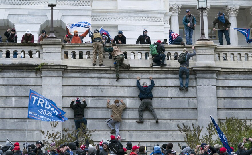 Supporters of President Trump climb the west wall of the U.S. Capitol on Jan. 6, 2021.
