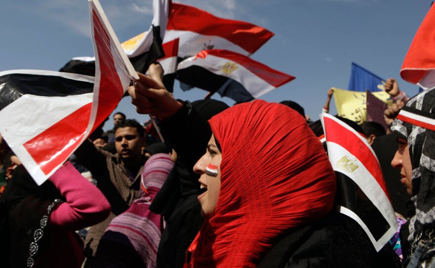 Women chant slogans and wave the Egyptian flag during a rally March 11 to support national unity of Muslims and Christians in Cairo's Tahrir Square, the focal point of the uprising that ousted Hosni Mubarak.