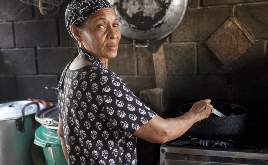 Felicia Ospino cooks at her beach-side fish restaurant in Necoclí. She complains that the migrants have scared away tourists.