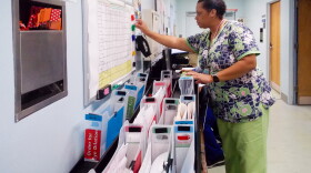 Nursing attendant Tracie Bell helps manage patients at the ophthalmology clinic at Los Angeles County Harbor-UCLA Medical Center. The clinic created a color-coded system to reduce wait times for patients.