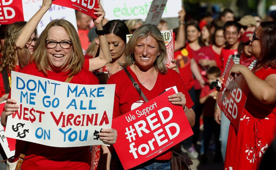 Arizona teachers and education advocates march at the Arizona Capitol protesting low teacher pay and school funding in Phoenix.