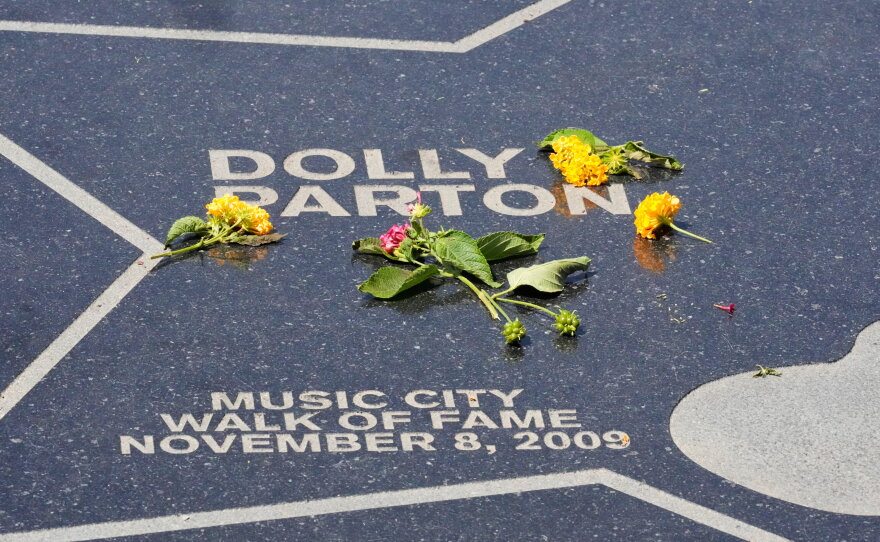 Flowers are placed on Dolly Parton's star at Walk of Fame Park on Tuesday, Aug. 25, 2026, in Nashville.