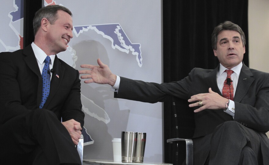 In friendlier times, Maryland Gov. Martin O'Malley, left, and Texas Gov. Rick Perry participate in a 2011 panel discussion in Washington, D.C. At the time, O'Malley was chairman of the Democratic Governors Association; Perry was chairman of the Republican Governors Association. Now they're in a spat over Perry's efforts to lure Maryland businesses to Texas.