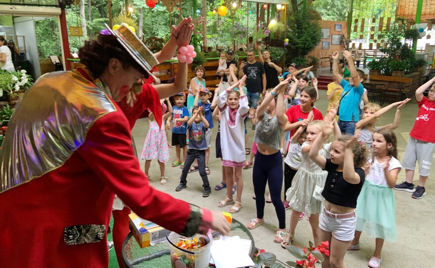 Igor and the children draw pictures, and they belt out patriotic folk songs. At one point, the clown asks them about their dreams. "I dreamed we beat the Russians," one girl says.