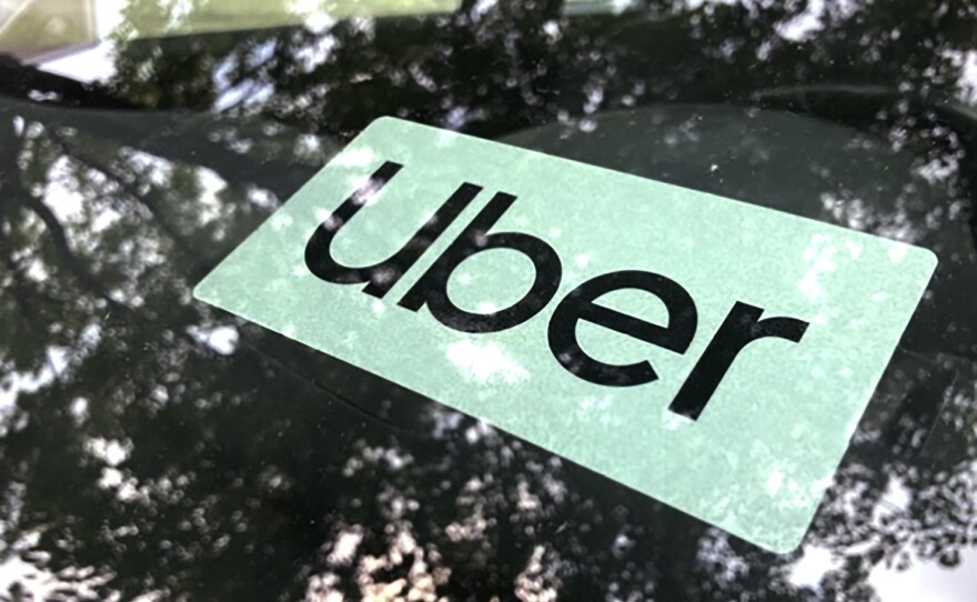 An Uber sign is displayed inside a car in Palatine, Ill., Monday, May 22, 2023.