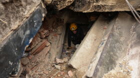 A member of the Los Angeles County Fire Department moves through the rubble of a building that collapsed from earthquakes in La Guaira, Venezuela, Tuesday.