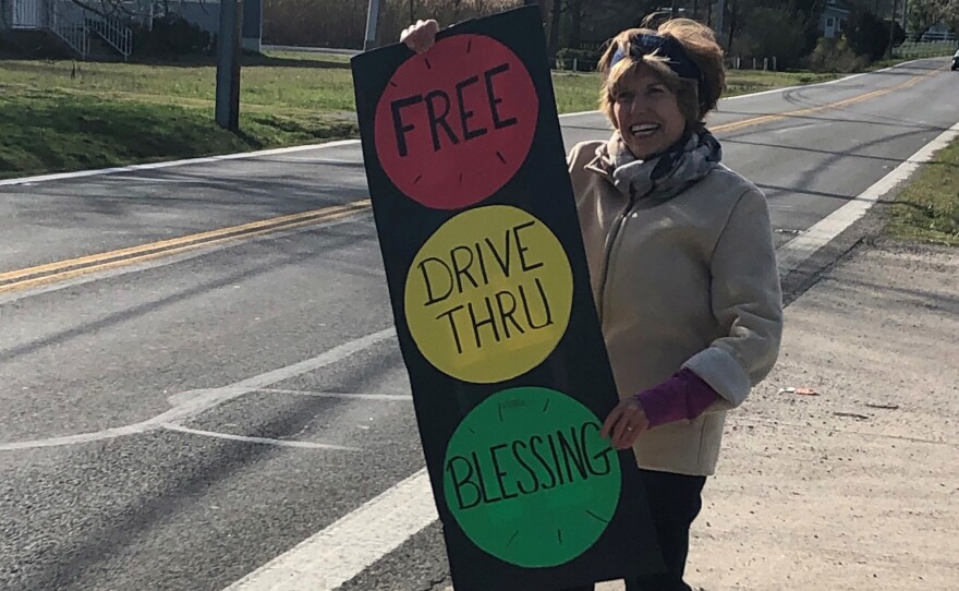 Carol Day, a lay volunteer at Centenary Methodist Church in Shady Side, Md., invites passers by to stop for a blessing.
