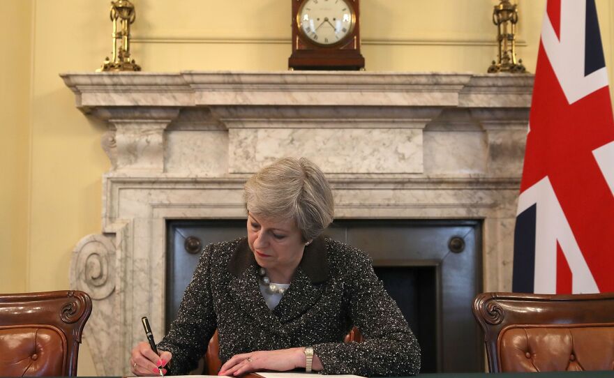 Britain's Prime Minister Theresa May signs the official letter to European Council President Donald Tusk invoking Article 50 and signaling the United Kingdom's intention to leave the EU.