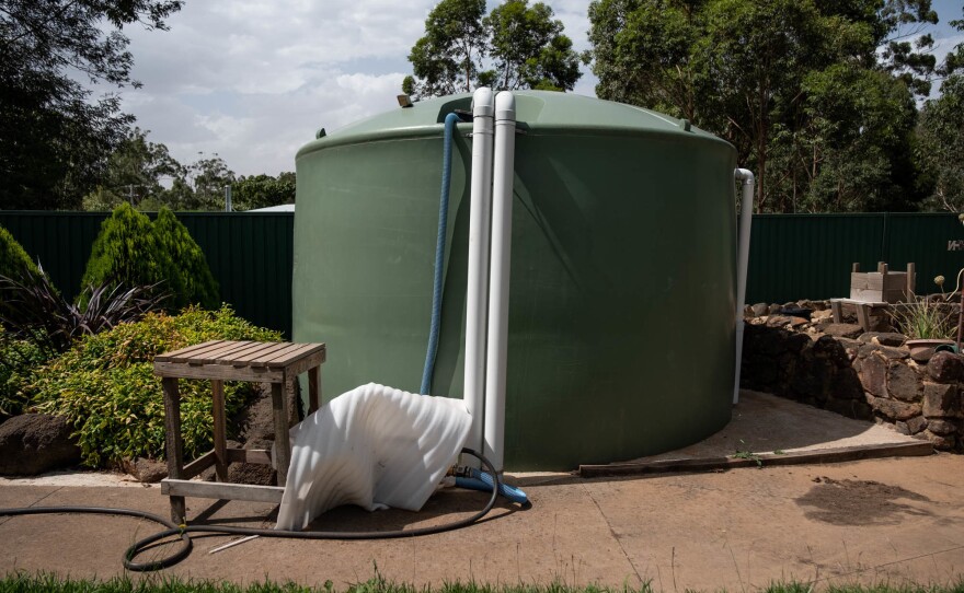 A tank of water sits outside Milbourne's home.