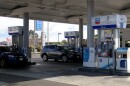 People fill up at a Chevron station in San Diego on December 7, 2022.