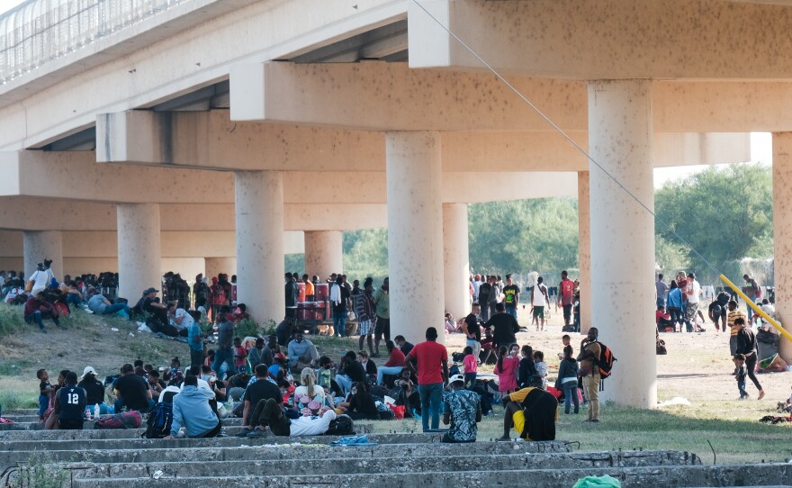 Migrants at the Rio Grande near the port of entry in Del Rio, Texas, on Saturday.