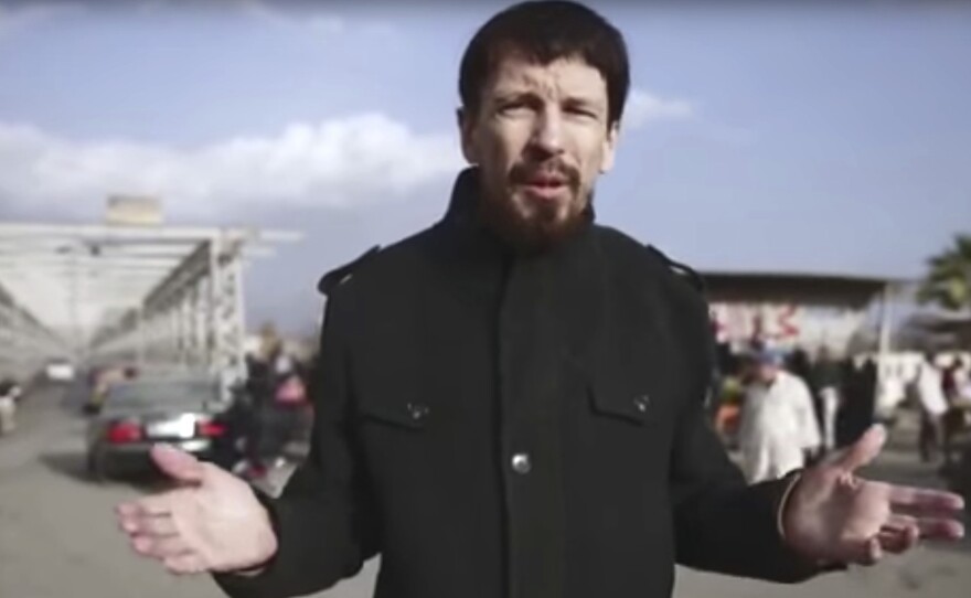 British photojournalist John Cantlie is seen in this video image released in December 2016 in what appeared to be central Mosul, Iraq. He was abducted by the Islamic State in 2012.