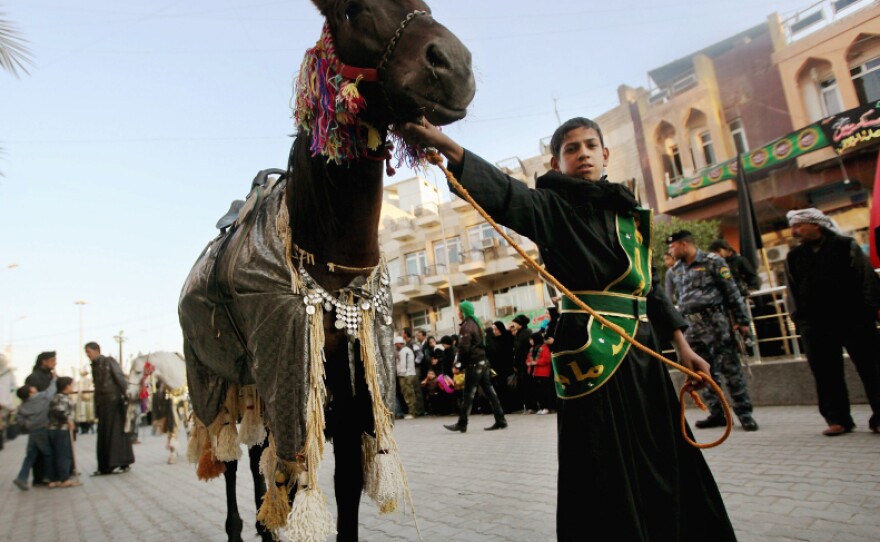 Iraqi Shiite Muslims march in a parade on Dec. 1 in Baghdad. As U.S. troops prepare to leave, the security situation in some parts of the country remains uncertain.
